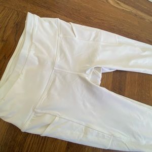 Lulu lemon size 4 leggings with zipper, panel and pocket detail.